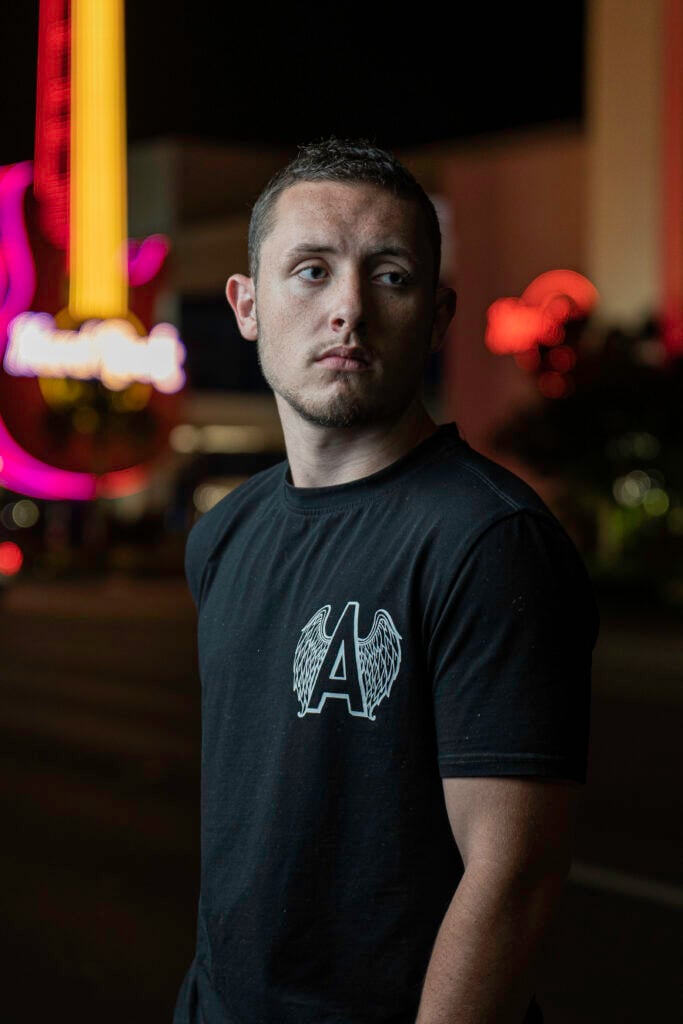 Person standing near colorful lights.
