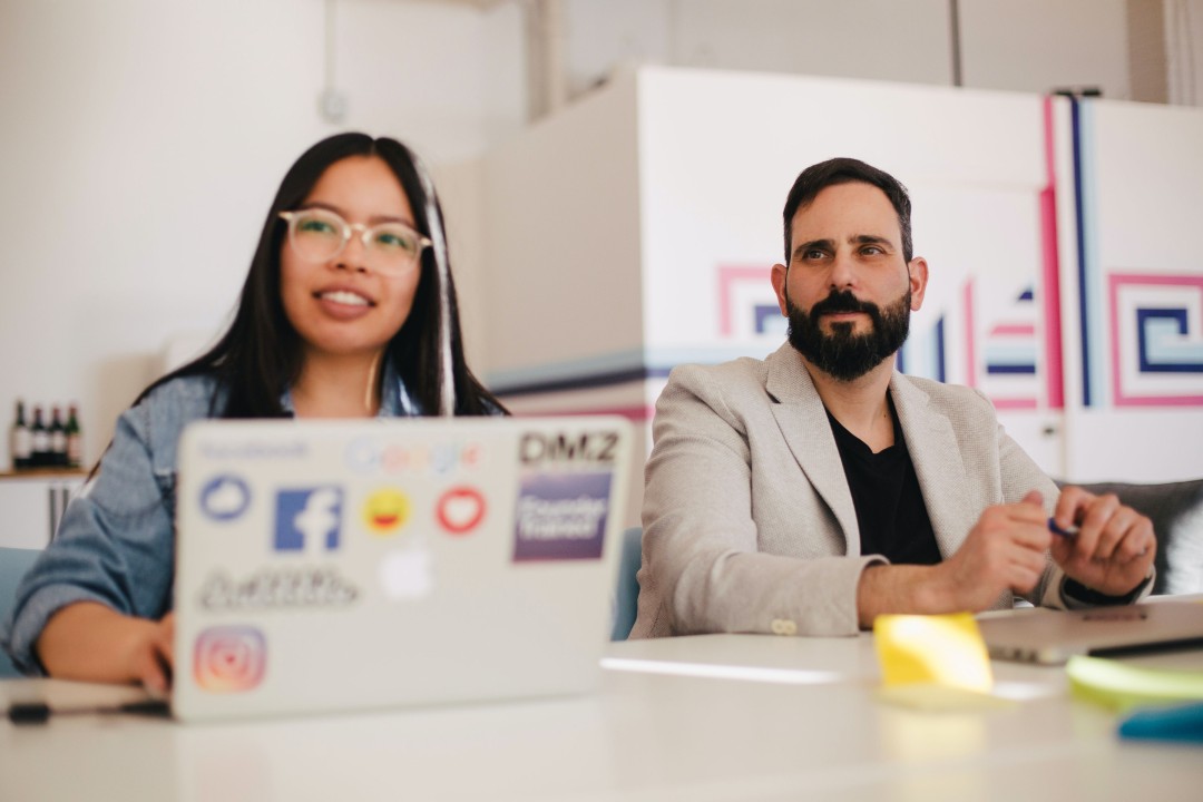 Two people working at a desk.